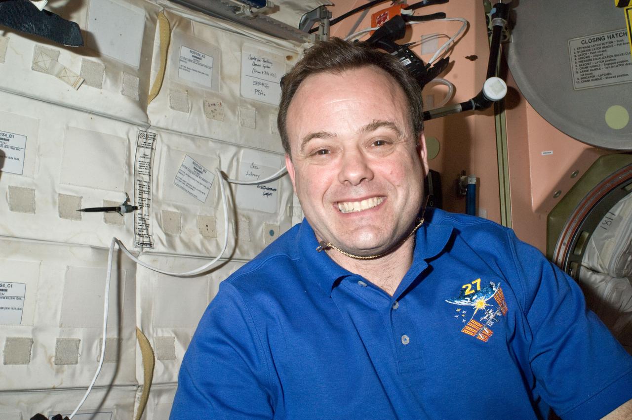 ISS027-E-035564 (21 May 2011) --- Astronaut Ron Garan, Expedition 27 flight engineer, appears to appreciate the progress being made by an aggregation of twelve astronauts and cosmonauts (including six Endeavour "guests") currently sharing work on the International Space Station (ISS). Today is a work day in between the first two spacewalk days on the joint Endeavour/ISS complex.