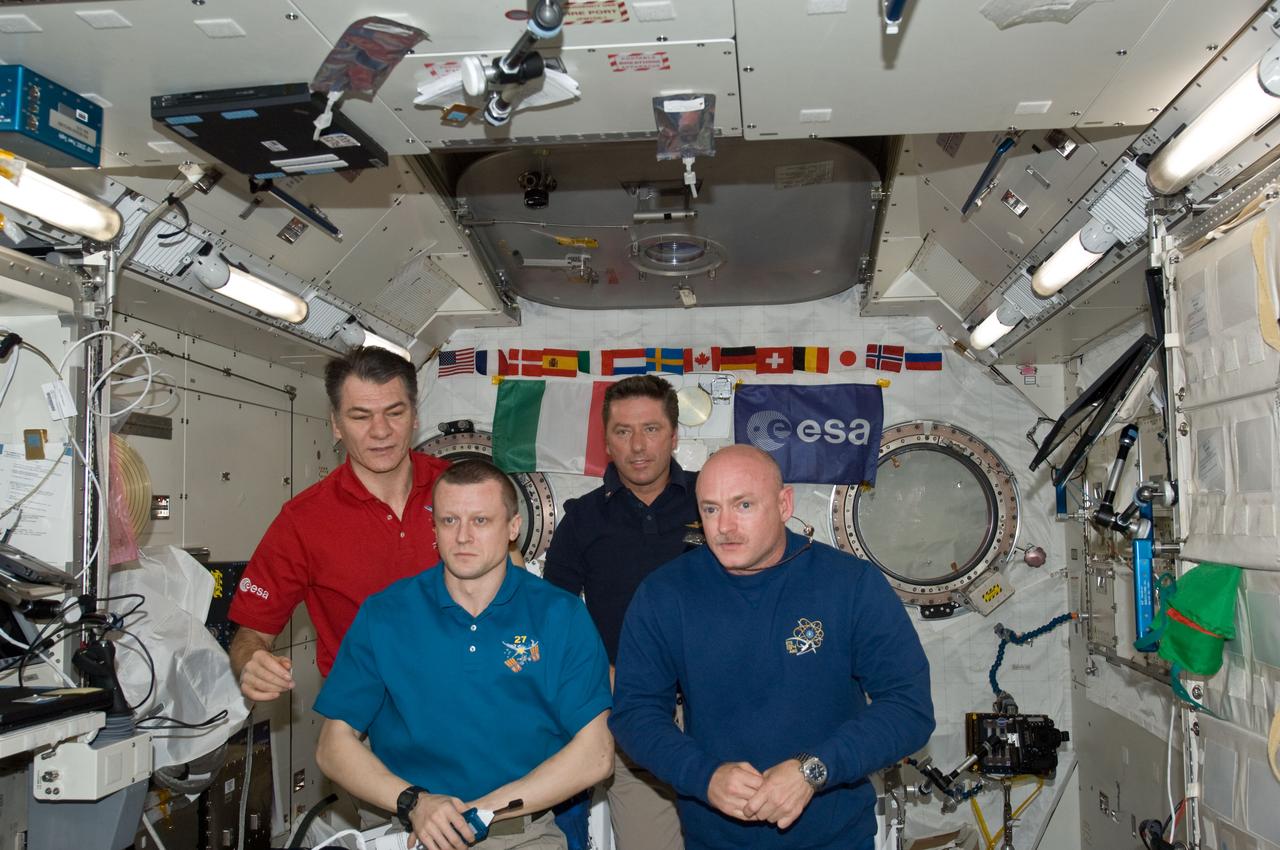 ISS027-E-036202 (23 May 2011) --- Inside the Japan Aerospace Exploration  Agency's Kibo lab on the International Space Station (ISS), European Space Agency astronauts Paolo Nespoli (left rear) and Roberto Vittori (right rear) during an Earth-to-space phone tag-up with  Italian President Giorgio Napolitano. Russian cosmonaut Dmitry Kondratyev (left front) and Mark Kelly, the respective commanders for the two, introduced the two ESA astronauts and left them in Kibo to visit with the president.  Nespoli has been on the station for over five months and is due to return to Earth in less than 24 hours. Vittori is on a 16-day mission of the space shuttle Endeavour,  joined by five NASA astronauts. This occasion is the second time two Italian astronauts have been in space together and the first time in the last 15 years.