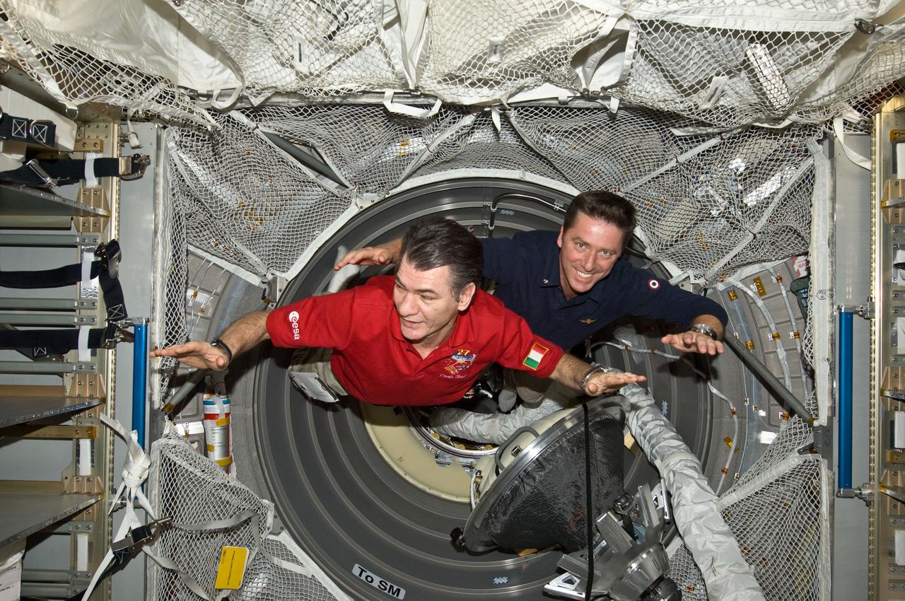 ISS027-E-036252 (23 May 2011) --- European Space Agency astronauts Paolo Nespoli (left), Expedition 27 flight engineer; and Roberto Vittori, STS-134 mission specialist, are pictured in the European Space Agency's "Johannes Kepler" Automated Transfer Vehicle-2 (ATV-2) currently docked to the International Space Station following an Earth-to-space phone tag-up with Italian President Giorgio Napolitano. Nespoli has been on the station for over five months and is due to return to Earth in less than 24 hours. Vittori is on a 16-day mission of the space shuttle Endeavour, joined by five NASA astronauts. This occasion is the second time two Italian astronauts have been in space together and the first time in the last 15 years.