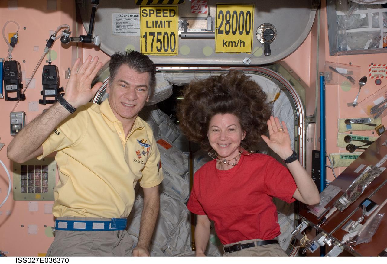 ISS027-E-036370 (23 May 2011) --- NASA astronaut Cady Coleman and European Space Agency astronaut Paolo Nespoli, both Expedition 27 flight engineers, wave to the camera in the Unity node as they make preparations to board the Soyuz TMA-20 spacecraft that will return them, along with Russian cosmonaut Dmitry Kondratyev (out of frame), commander, to Earth.