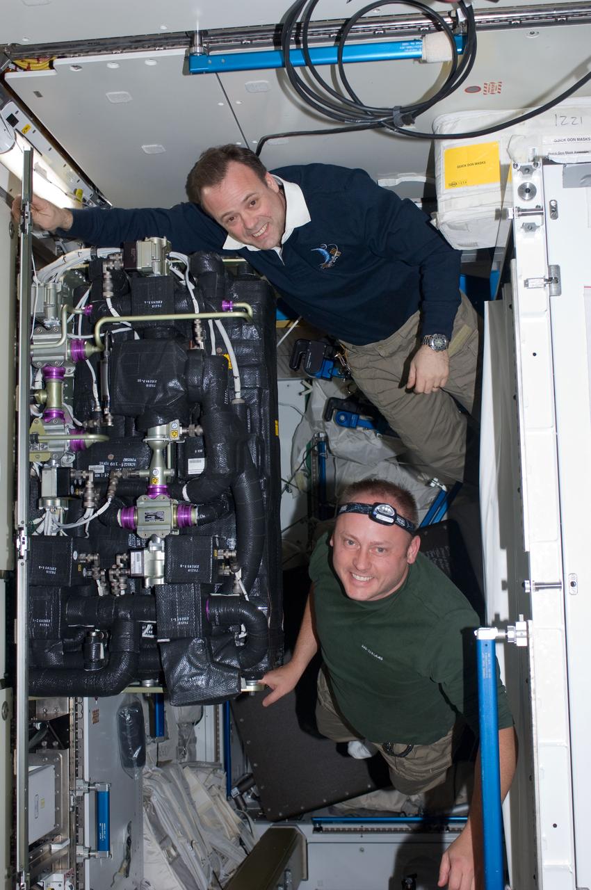 ISS028-E-005117 (24 May 2011) --- NASA astronauts Michael Fincke (bottom), STS-134 mission specialist; and Ron Garan, Expedition 28 flight engineer, perform maintenance on the Carbon Dioxide Removal Assembly (CDRA) in the Air Revitalization 2 (AR2) rack in the Tranquility node of the International Space Station while space shuttle Endeavour remains docked with the station.