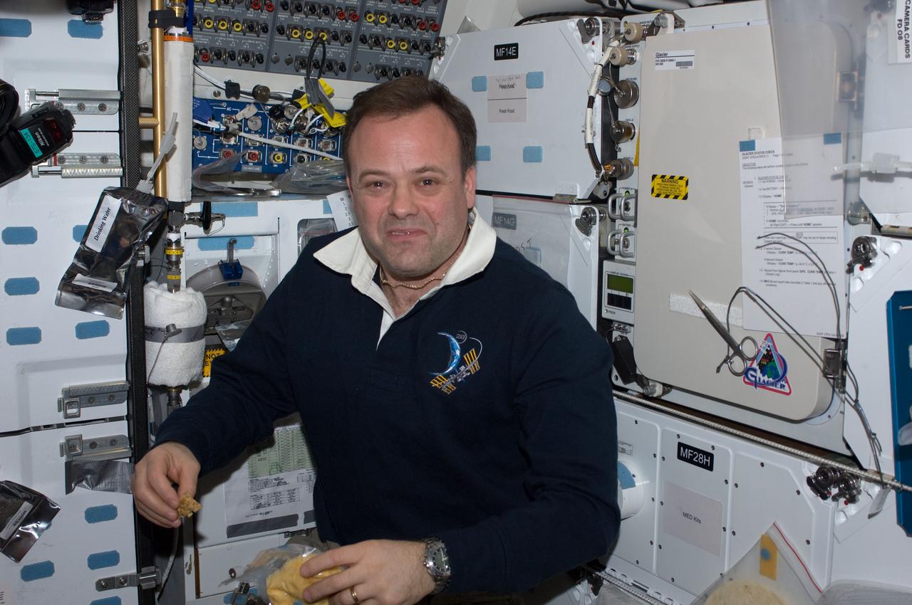 ISS028-E-005141 (24 May 2011) --- NASA astronaut Ron Garan, Expedition 28 flight engineer, enjoys a snack on the middeck of space shuttle Endeavour (STS-134) while docked with the International Space Station.