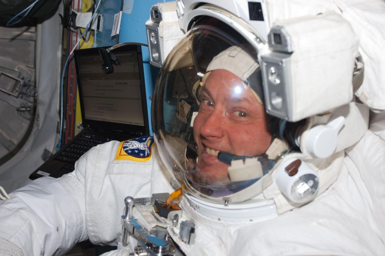 ISS028-E-005233 (25 May 2011) --- NASA astronaut Michael Fincke, STS-134 mission specialist, attired in an Extravehicular Mobility Unit (EMU) spacesuit, is pictured in the Quest airlock of the International Space Station prior to the start of the mission?s third session of extravehicular activity (EVA).