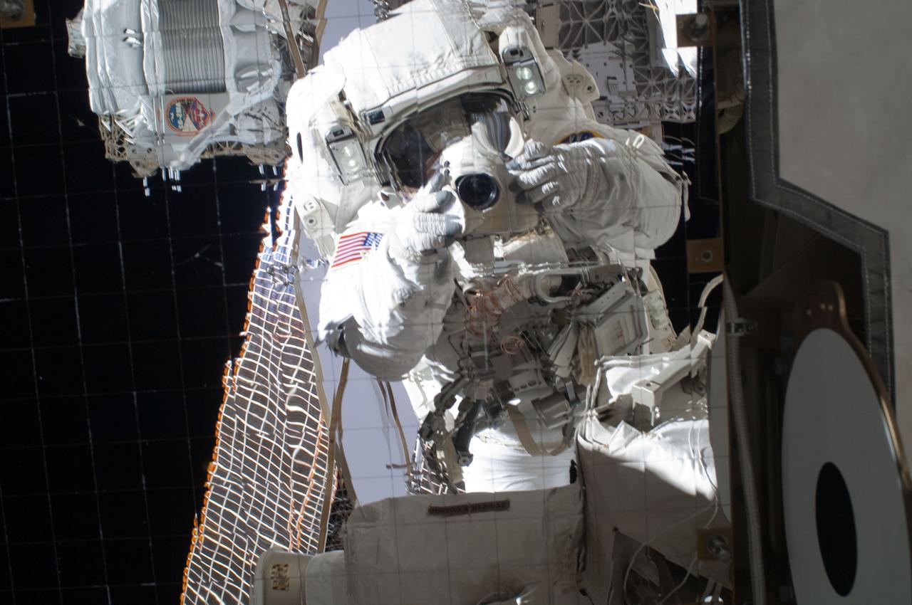 ISS028-E-005584 (25 May 2011) --- NASA astronaut Michael Fincke, STS-134 mission specialist, uses a digital still camera during the STS-134 mission’s third session of extravehicular activity (EVA) as construction and maintenance continue on the International Space Station.