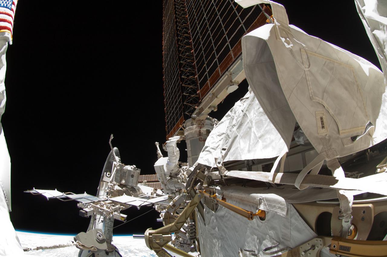 ISS028-E-005627 (27 May 2011) --- A fish-eye lens attached to an electronic still camera was used to capture this image of NASA astronaut Michael Fincke (bottom center) during the mission's fourth session of extravehicular activity (EVA) as construction and maintenance continue on the International Space Station. During the seven-hour, 24-minute spacewalk, Fincke and astronaut Greg Chamitoff (out of frame), both STS-134 mission specialists, completed the primary objectives for the spacewalk, including stowing the 50-foot-long boom and adding a power and data grapple fixture to make it the Enhanced International Space Station Boom Assembly, available to extend the reach of the space station's robotic arm. The docked space shuttle Endeavour is visible at bottom left.