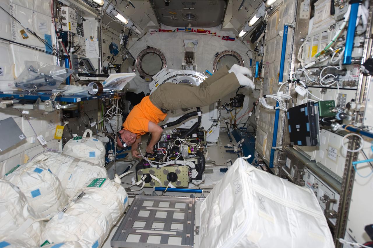 ISS028-E-005981 (28 May 2011) --- NASA astronaut Michael Fincke, STS-134 mission specialist, performs maintenance on the Carbon Dioxide Removal Assembly in the Kibo laboratory of the International Space Station while space shuttle Endeavour remains docked with the station.