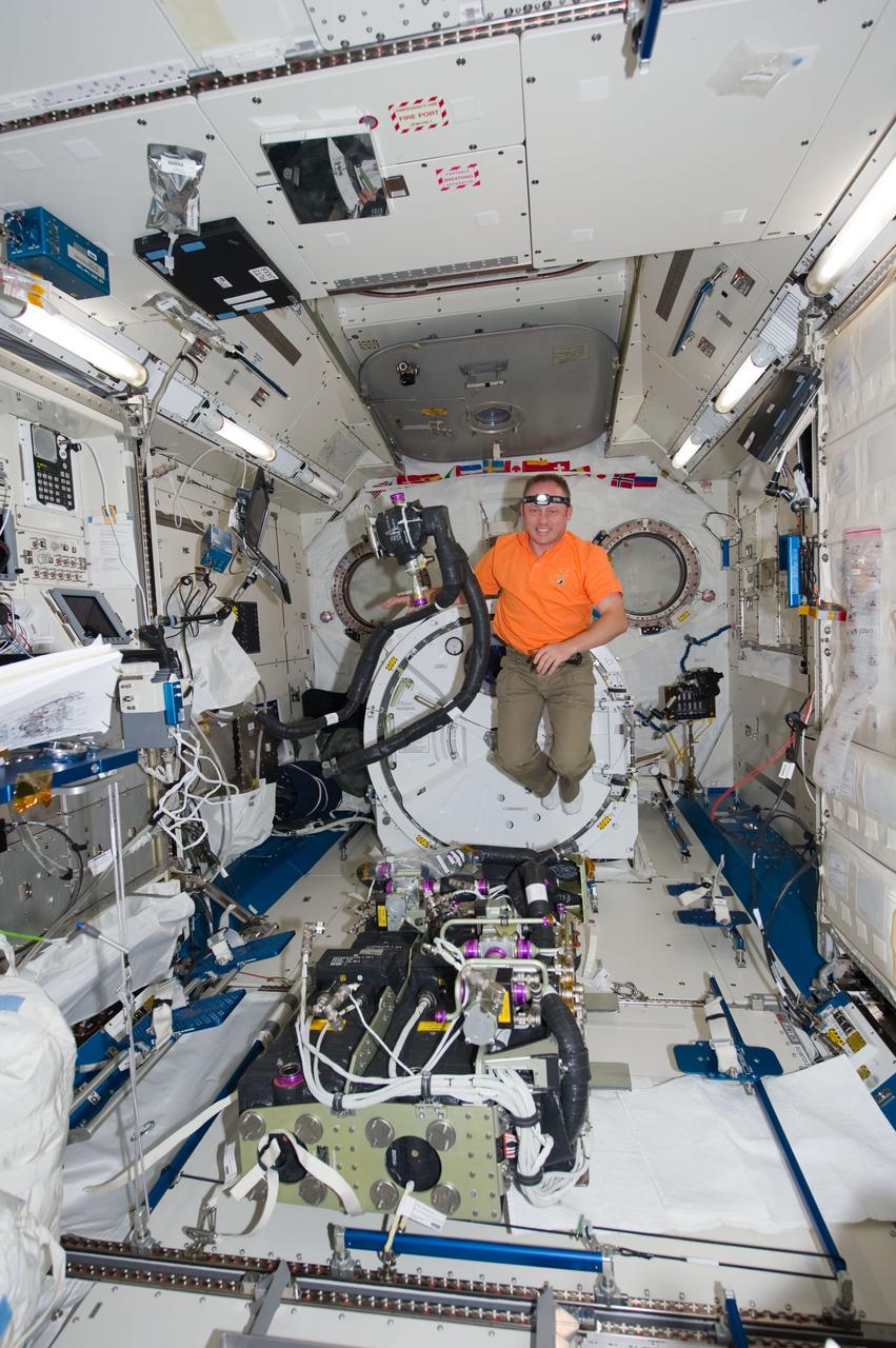 ISS028-E-005987 (28 May 2011) --- NASA astronaut Michael Fincke, STS-134 mission specialist, performs maintenance on the Carbon Dioxide Removal Assembly in the Kibo laboratory of the International Space Station while space shuttle Endeavour remains docked with the station.