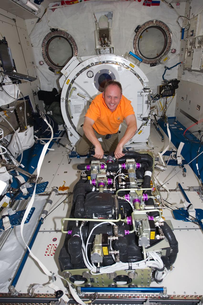 ISS028-E-006015 (28 May 2011) --- NASA astronaut Michael Fincke, STS-134 mission specialist, performs maintenance on the Carbon Dioxide Removal Assembly in the Kibo laboratory of the International Space Station while space shuttle Endeavour remains docked with the station.