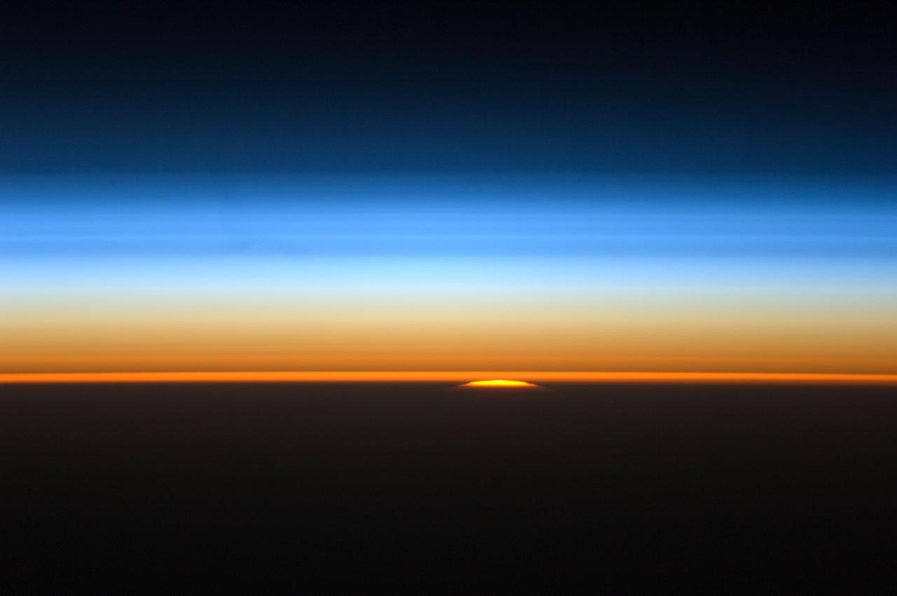 ISS028-E-007274 (11 June 2011) --- This view of the sun peeking over the limb of the Earth was taken by the Expedition 28 crew members aboard the International Space Station while flying parallel to the terminator; the area between daylight and nighttime. This lighting condition occurs in the early summer and late fall for the station's orbit tracks. The rest of the year the orbital outpost passes through the terminator at angles to experience 16 sunrises and sunsets a day. All of the layers of the Earth?s atmosphere are depicted in a beautiful array of color lit by the sun; from near the surface to the darkness of space.