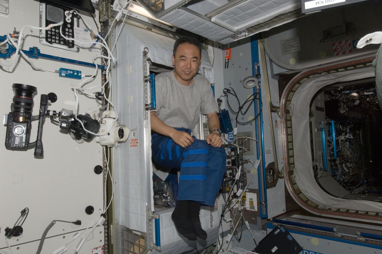 ISS028-E-007685 (12 June 2011) --- Japan Aerospace Exploration Agency astronaut Satoshi Furukawa, Expedition 28 flight engineer, is pictured in the doorway of his crew quarters compartment in the Harmony node of the International Space Station.