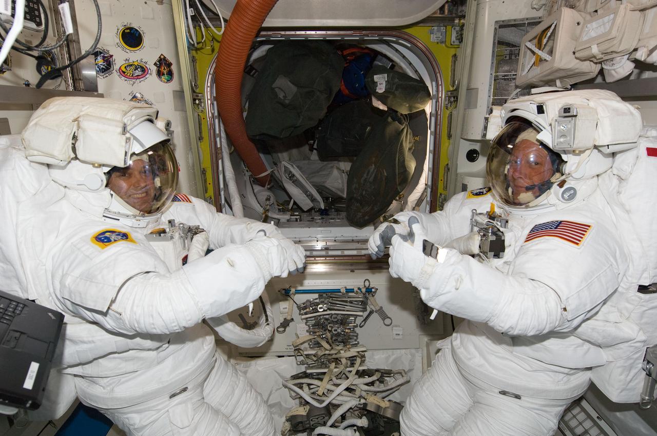 ISS028-E-009216 (22 June 2011) --- NASA astronauts Ron Garan (left) and Mike Fossum, both Expedition 28 flight engineers, attired in their Extravehicular Mobility Unit (EMU) spacesuits, are pictured in the Quest airlock of the International Space Station. Garan and Fossum were participating in a ?dry run? in preparation for a planned spacewalk during STS-135/ULF-7.
