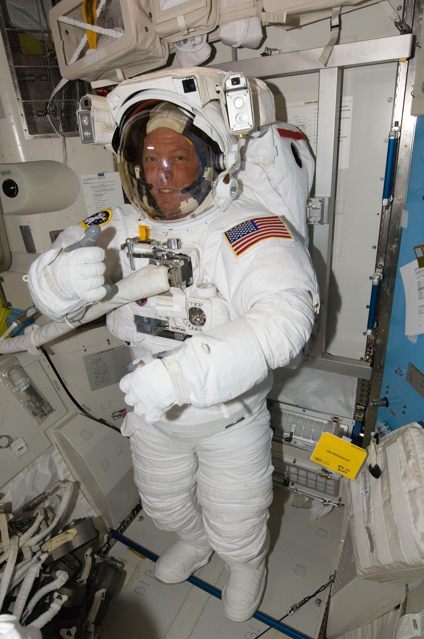 ISS028-E-009218 (22 June 2011) --- NASA astronaut Mike Fossum, attired in his Extravehicular Mobility Unit (EMU) spacesuit, is pictured in the Quest airlock of the International Space Station. Fossum and NASA astronaut Ron Garan (out of frame), both Expedition 28 flight engineers, were participating in a ?dry run? in preparation for a planned spacewalk during STS-135/ULF-7.