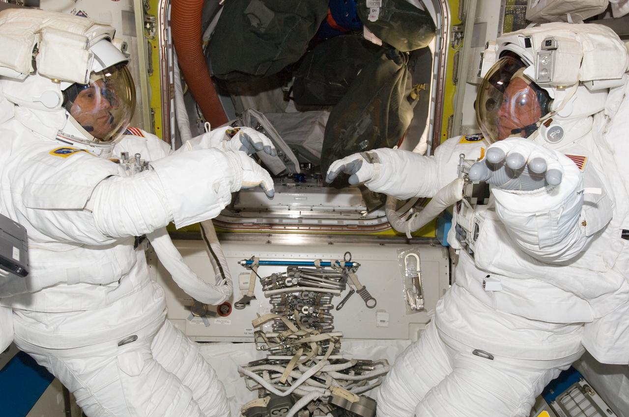 ISS028-E-009234 (22 June 2011) --- NASA astronauts Ron Garan (left) and Mike Fossum, both Expedition 28 flight engineers, attired in their Extravehicular Mobility Unit (EMU) spacesuits, are pictured in the Quest airlock of the International Space Station. Garan and Fossum were participating in a ?dry run? in preparation for a planned spacewalk during STS-135/ULF-7.
