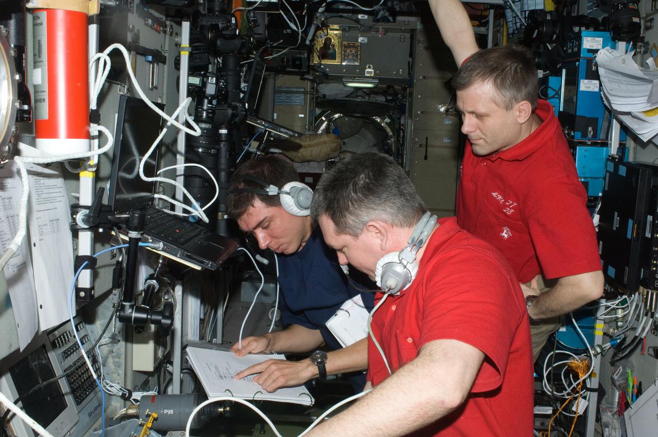 ISS028-E-009282 (23 June 2011) --- Russian cosmonauts Andrey Borisenko (right), Expedition 28 commander; Alexander Samokutyaev (foreground) and Sergei Volkov, both flight engineers, monitor data at the manual TORU docking system controls in the Zvezda Service Module of the International Space Station during the docking operations of the unpiloted ISS Progress 43 resupply vehicle. Progress 43 docked automatically to Zvezda?s aft port via the Kurs automated rendezvous system at 12:37 p.m. (EDT) on June 23, 2011.