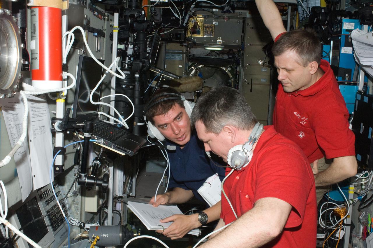 ISS028-E-009283 (23 June 2011) --- Russian cosmonauts Andrey Borisenko (right), Expedition 28 commander; Alexander Samokutyaev (foreground) and Sergei Volkov, both flight engineers, monitor data at the manual TORU docking system controls in the Zvezda Service Module of the International Space Station during the docking operations of the unpiloted ISS Progress 43 resupply vehicle. Progress 43 docked automatically to Zvezda?s aft port via the Kurs automated rendezvous system at 12:37 p.m. (EDT) on June 23, 2011.