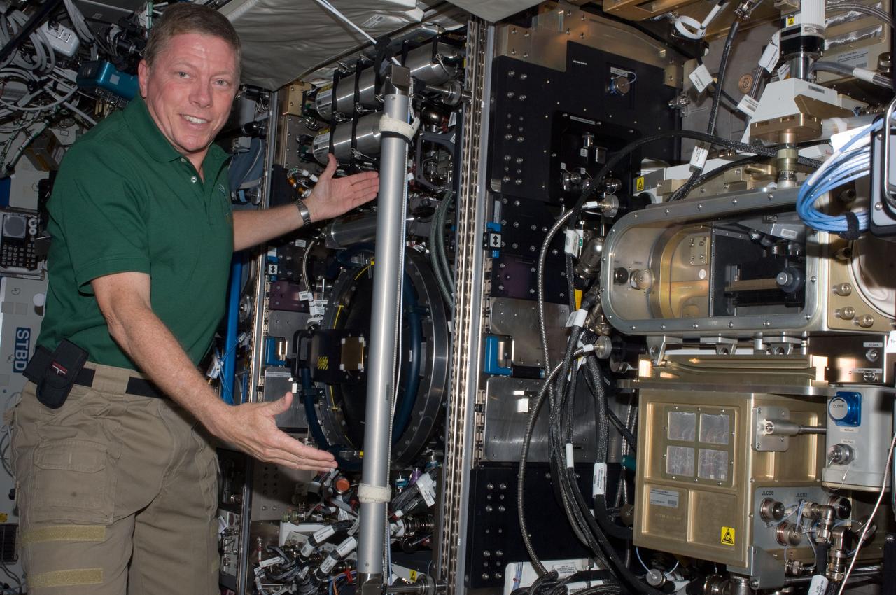 ISS028-E-009889 (26 June 2011) --- NASA astronaut Mike Fossum, Expedition 28 flight engineer, is pictured near the Combustion Integrated Rack (CIR) Multi-user Drop Combustion Apparatus (MDCA) in the Destiny laboratory of the International Space Station.