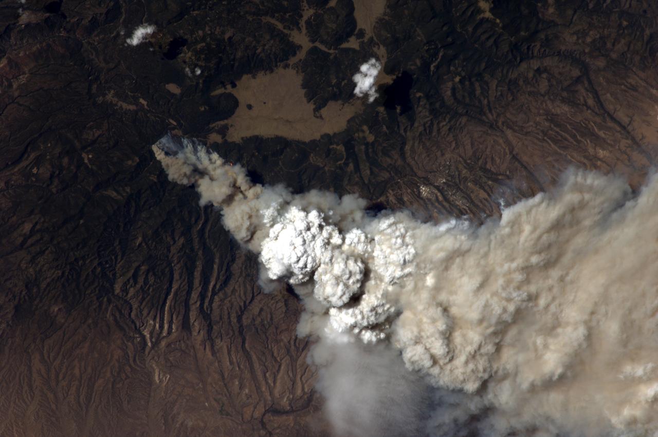 ISS028-E-010043 (27 June 2011) --- A crew member aboard the International Space Station, flying at an altitude of approximately 235 statute miles on June 27, 2011, exposed this still photograph of a major fire in the Jemez Mountains of the Santa Fe National Forest in north-central New Mexico. The fire is just southwest of Los Alamos National Laboratories, which can be seen just right of center.