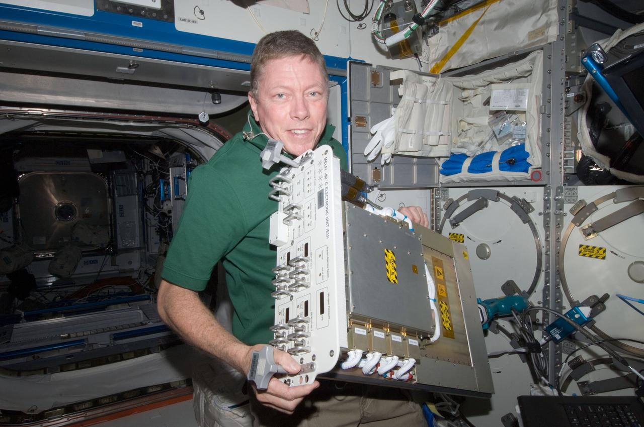 ISS028-E-013797 (1 July 2011) --- NASA astronaut Mike Fossum, Expedition 28 flight engineer, replaces a failed electronic unit for the Minus Eighty Laboratory Freezer for ISS 3 (MELFI-3) with a spare unit in the Kibo laboratory of the International Space Station.