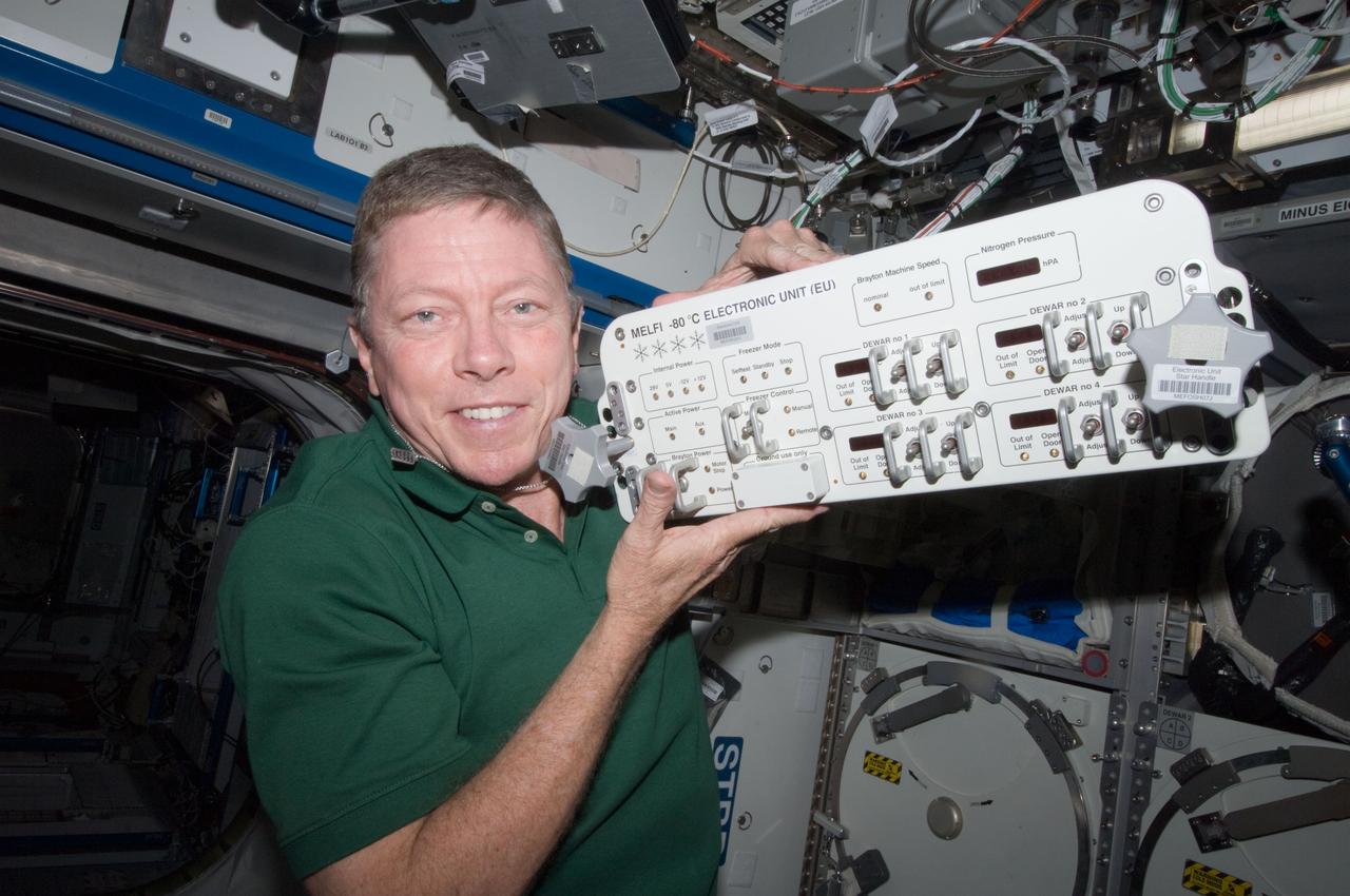 ISS028-E-013799 (1 July 2011) --- NASA astronaut Mike Fossum, Expedition 28 flight engineer, replaces a failed electronic unit for the Minus Eighty Laboratory Freezer for ISS 3 (MELFI-3) with a spare unit in the Kibo laboratory of the International Space Station.
