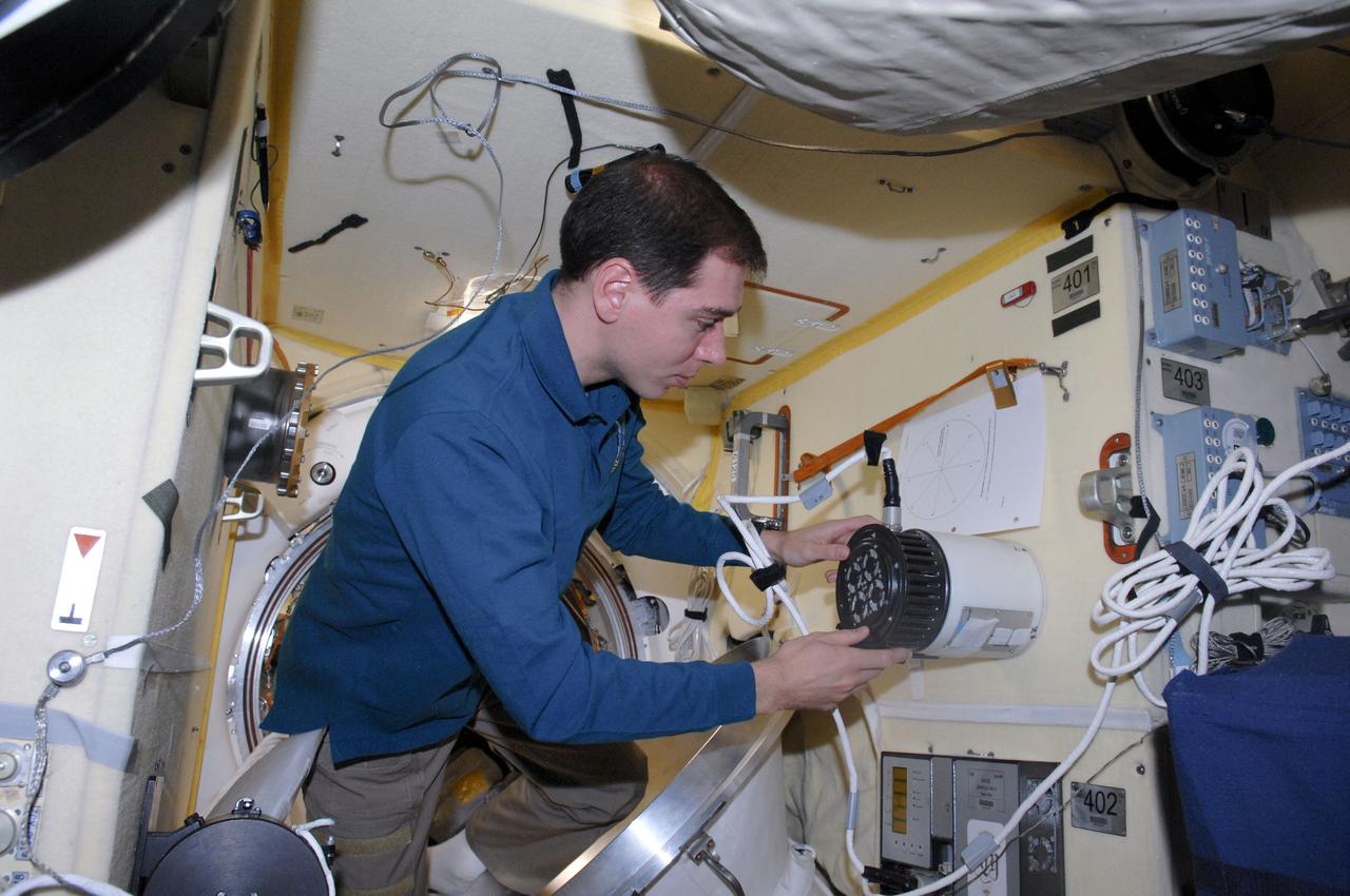 ISS028-E-014320 (6 July 2011) --- Russian cosmonaut Sergei Volkov, Expedition 28 flight engineer, works with the Russian TEKh-15/DAKON-M IZGIB (?Bend?) experiment in the Poisk Mini-Research Module 2 (MRM2) of the International Space Station.