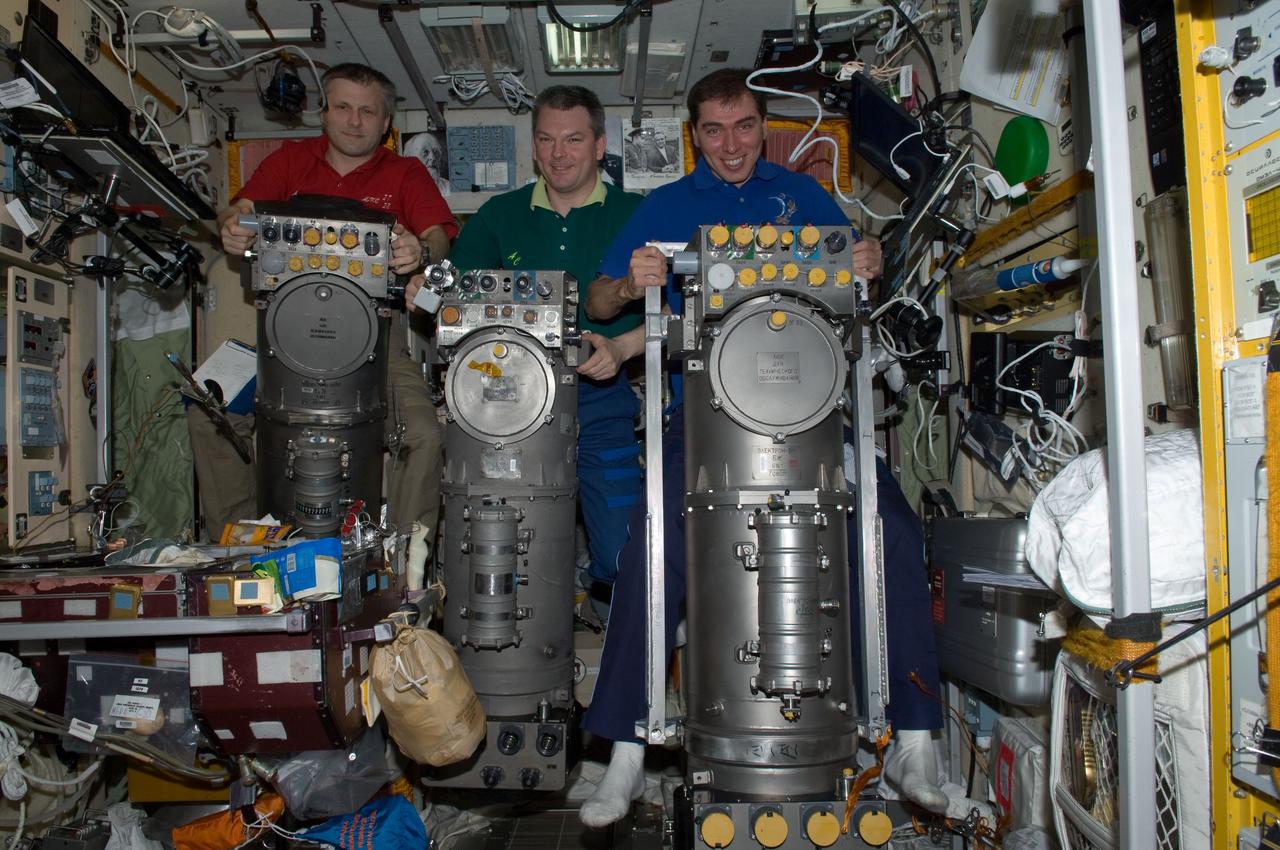 ISS028-E-014909 (8 July 2011) --- Russian cosmonauts Andrey Borisenko (left), Expedition 28 commander; Alexander Samokutyaev (center) and Sergei Volkov, both flight engineers, are pictured with Russian Elektron oxygen generator systems in the Zvezda Service Module of the International Space Station.