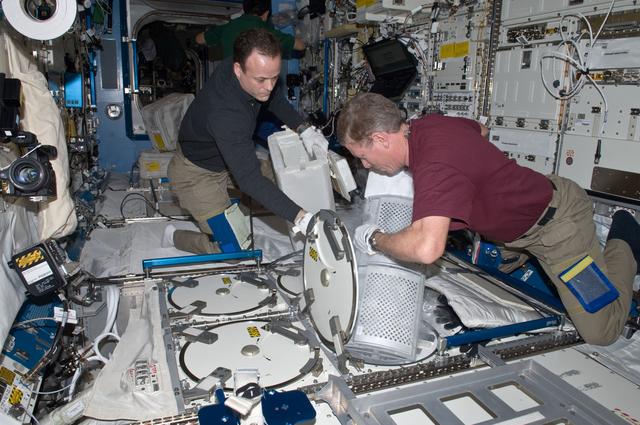 NASA image: Expedition 28 Crew Members remove samples from the JPM MELFI