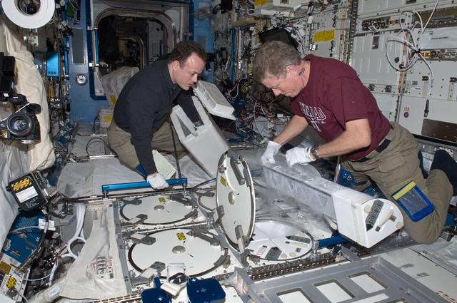 NASA image: Expedition 28 Crew Members remove samples from the JPM MELFI