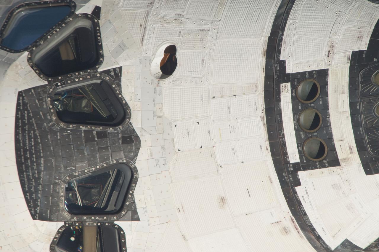 ISS028-E-015086   (10 July 2011) --- This is one of a series of images showing various parts of the space shuttle Atlantis in Earth orbit as photographed by one of the six crewmembers on the International Space Station as the shuttle “posed” for photo and visual surveys and performed a back-flip for the rendezvous pitch maneuver (RPM).  An 800 millimeter lens was used to capture this particular series of images.