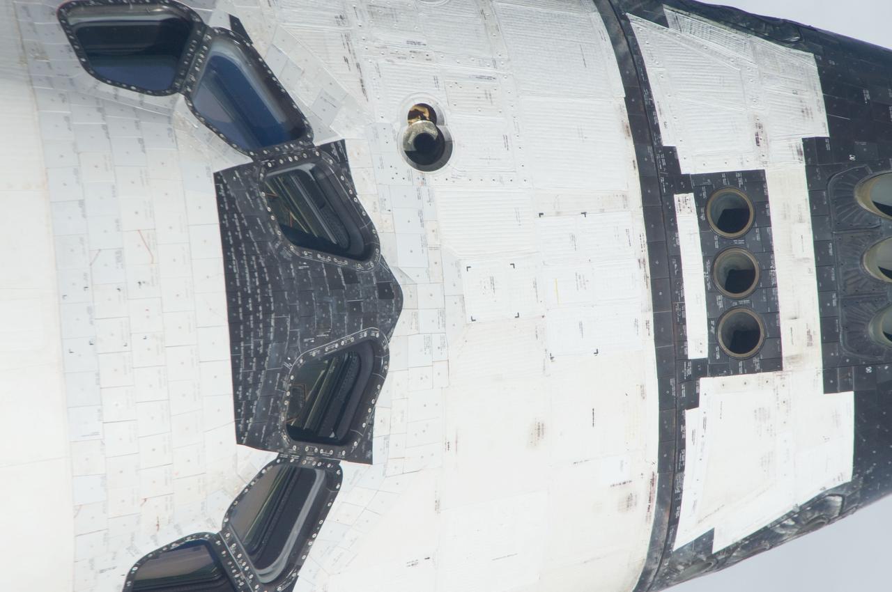 ISS028-E-015116 (10 July 2011) --- This is one of a series of images showing various parts of the space shuttle Atlantis in Earth orbit as photographed by one of the six crewmembers on the International Space Station as the shuttle “posed” for photo and visual surveys and performed a back-flip for the rendezvous pitch maneuver (RPM). An 800 millimeter lens was used to capture this particular series of images.