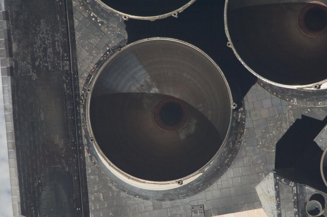 ISS028-E-015328 (10 July 2011) --- Parts of Atlantis' set of main engines are visible in one of a series of images showing various parts of the space shuttle in Earth orbit as photographed by one of the six crewmembers on the International Space Station as the shuttle “posed” for photo and visual surveys and performed a back-flip for the rendezvous pitch maneuver (RPM). An 800 millimeter lens was used to capture this particular series of images.
