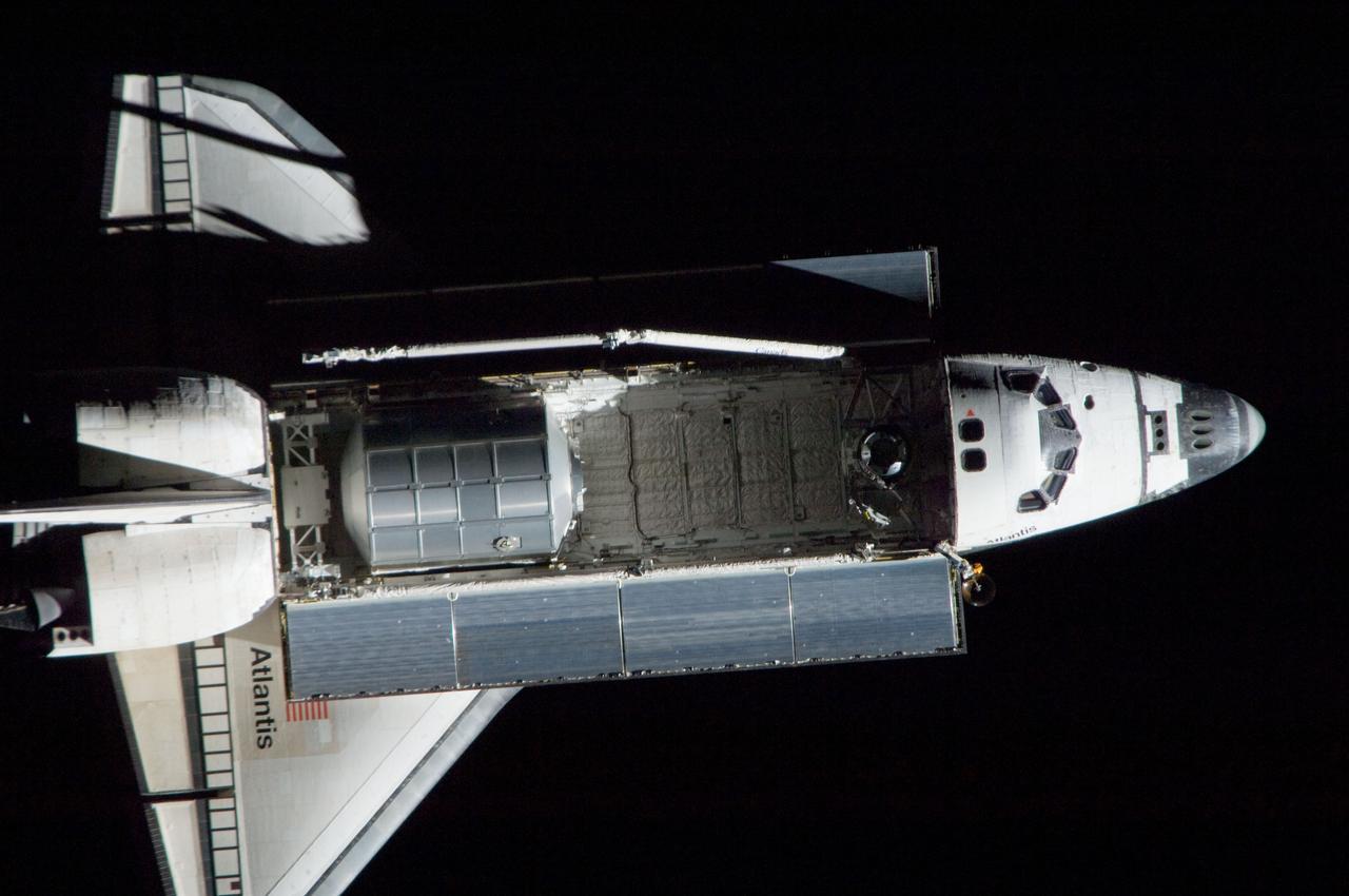 ISS028-E-015374 (10 July 2011) --- A nadir view of the space shuttle Atlantis and its payload is provided by one of a series of images showing various parts of the shuttle in Earth orbit. Seen at the rear of the cargo bay is the Raffaello multi-purpose logistics module, packed with supplies and spare parts for the International Space Station.  The series was photographed by one of three crewmembers -- half the station crew -- who were equipped with still cameras on the  orbiting outpost as the shuttle “posed” for photo and visual surveys and performed a back-flip for the rendezvous pitch maneuver (RPM). An 800 millimeter lens was used to capture this particular series of images.