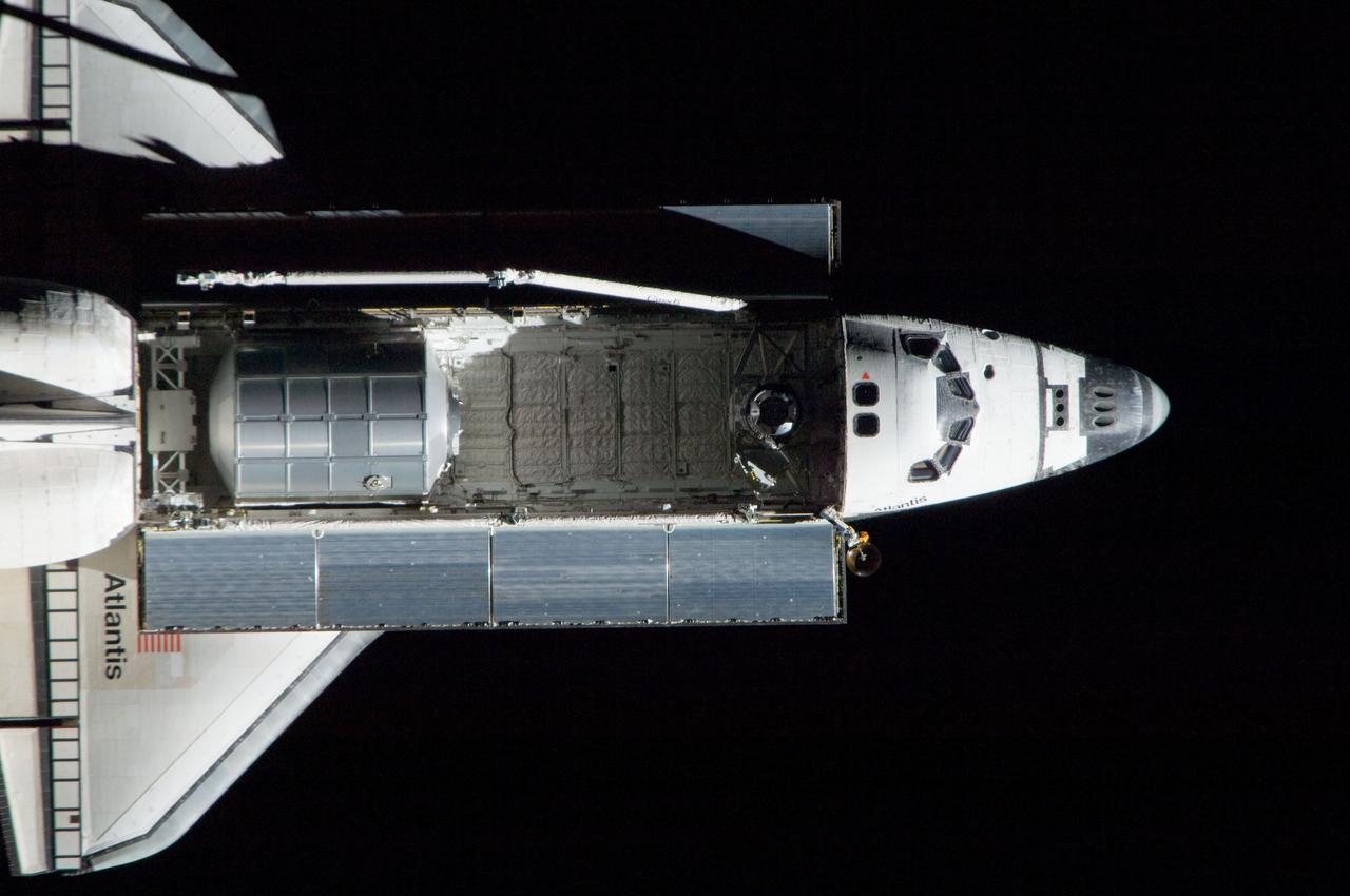 ISS028-E-015375 (10 July 2011) --- A nadir view of the space shuttle Atlantis and its payload is provided by one of a series of images showing various parts of the shuttle in Earth orbit. Seen at the rear of the cargo bay is the Raffaello multi-purpose logistics module, packed with supplies and spare parts for the International Space Station.  The series was photographed by one of three crewmembers -- half the station crew -- who were equipped with still cameras on the  orbiting outpost as the shuttle “posed” for photo and visual surveys and performed a back-flip for the rendezvous pitch maneuver (RPM). An 800 millimeter lens was used to capture this particular series of images.