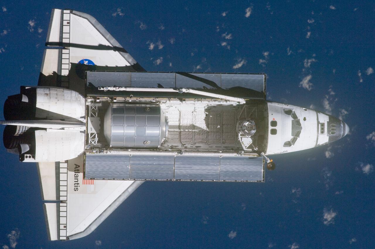 ISS028-E-015566 (10 July 2011) --- A nadir view of the space shuttle Atlantis and its payload was provided by one of a series of images showing various parts of the shuttle in Earth orbit. Seen at the rear of the cargo bay is the Raffaello multi-purpose logistics module, packed with supplies and spare parts for the International Space Station. The series was photographed by one of three crewmembers -- half the station crew -- who were equipped with still cameras on the orbiting outpost as the shuttle “posed” for photos and visual surveys and performed a back-flip for the rendezvous pitch maneuver (RPM). A 400 millimeter lens was used to capture this particular series of images.