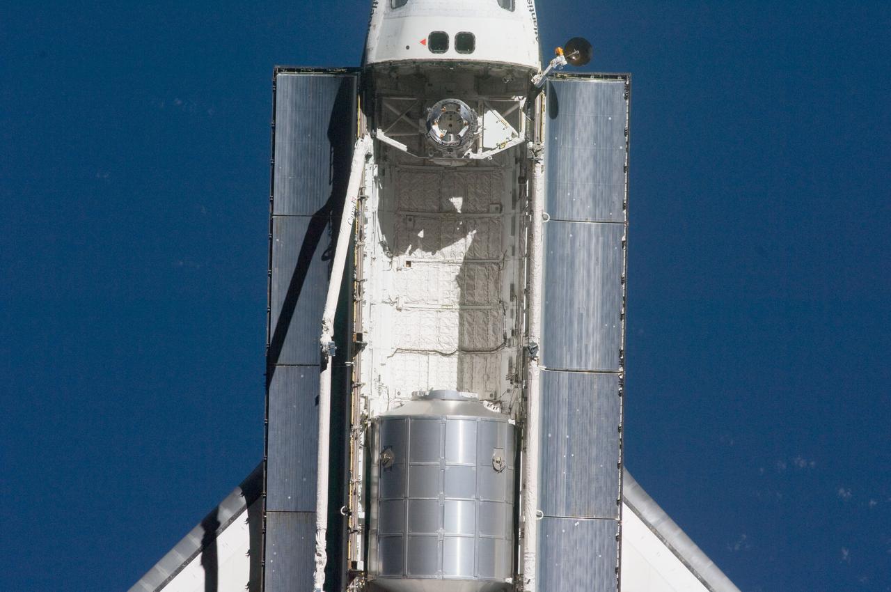 ISS028-E-015571 (10 July 2011) --- A nadir view of the space shuttle Atlantis and its payload is provided by one of a series of images showing various parts of the shuttle in Earth orbit. Seen at the rear of the cargo bay is the Raffaello multi-purpose logistics module, packed with supplies and spare parts for the International Space Station. The series was photographed by one of three crewmembers -- half the station crew -- who were equipped with still cameras on the orbiting outpost as the shuttle “posed” for photo and visual surveys and performed a back-flip for the rendezvous pitch maneuver (RPM). A 400 millimeter lens was used to capture this particular series of images.