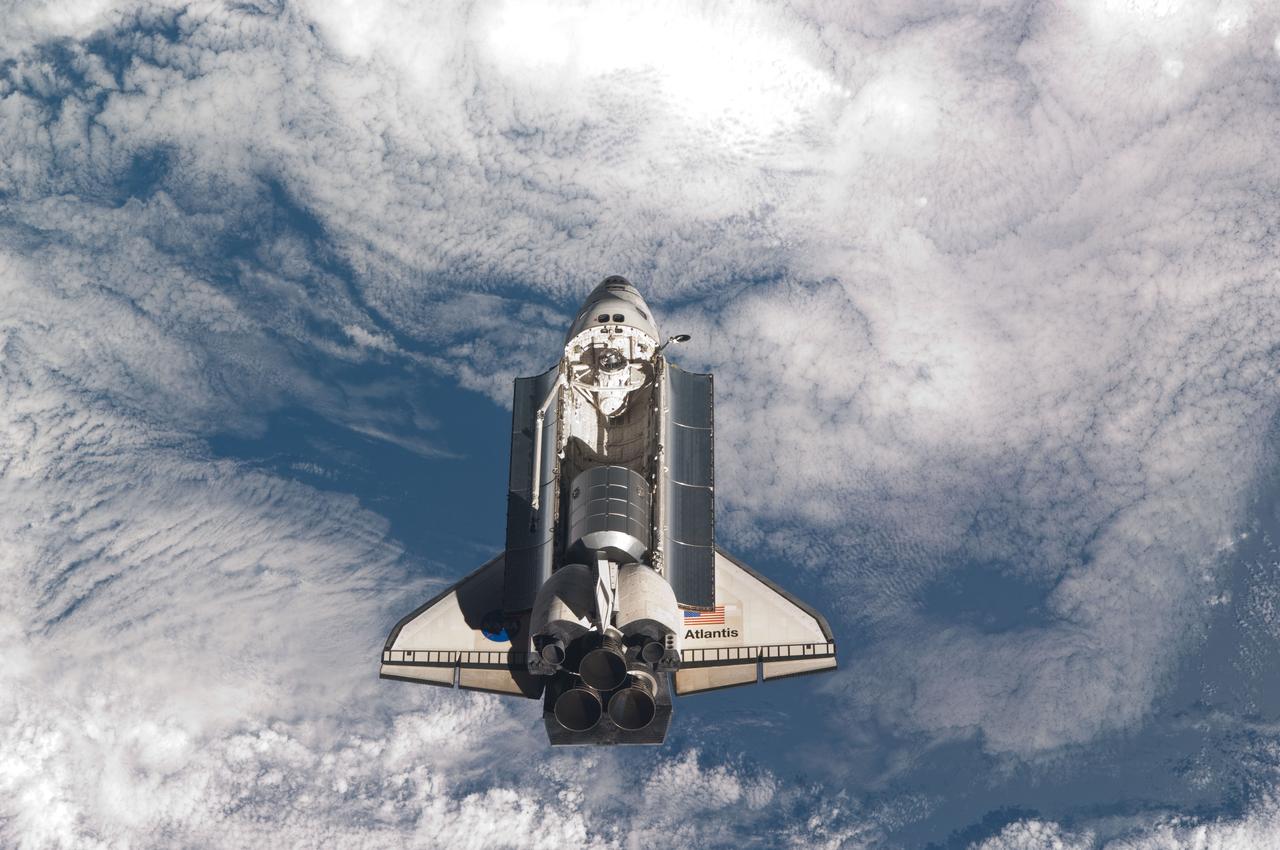 ISS028-E-015832 (10 July 2011) --- The space shuttle Atlantis is pictured over clouds prior to a perfect docking with the International Space Station at 10:07 a.m. (CDT).