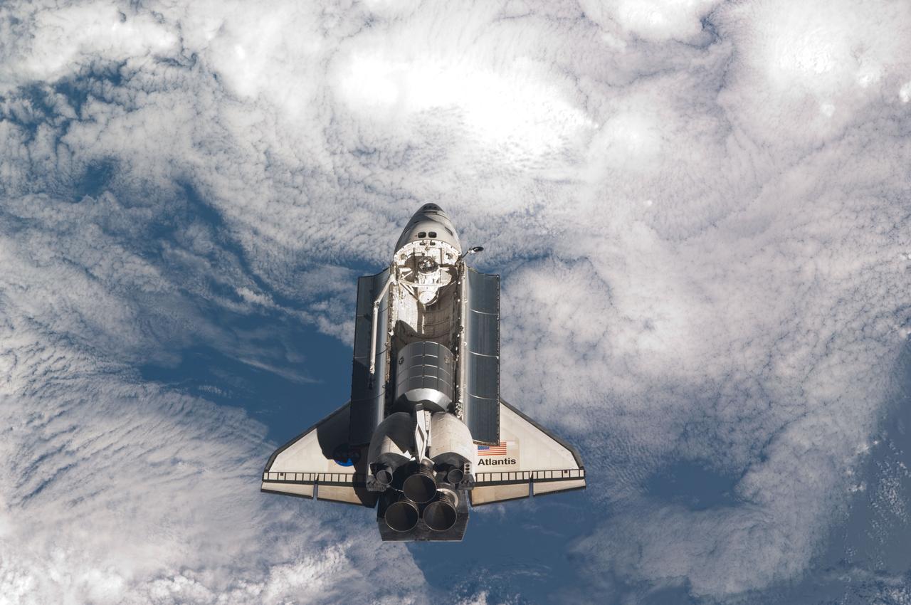 ISS028-E-015833 (10 July 2011) --- The space shuttle Atlantis is pictured over clouds prior to a perfect docking with the International Space Station at 10:07 a.m. (CDT).