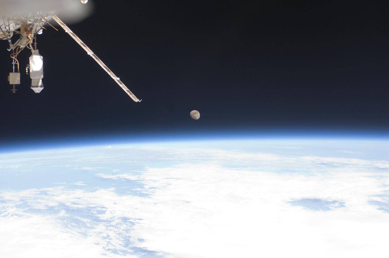 ISS028-E-016058 (12 July 2011) --- One of the Expedition 28 crewmembers aboard the International Space Center recorded this image of Earth's horizon and the moon during the week and a half period that the orbiting complex was hosting the Atlantis and its crew for the final Space Shuttle Program mission.