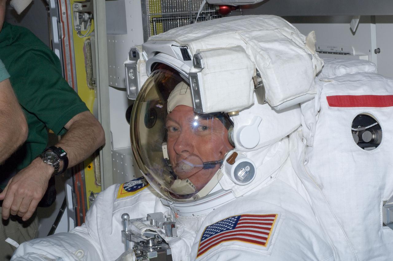 ISS028-E-016090 (12 July 2011) --- NASA astronaut Mike Fossum, Expedition 28 flight engineer, is pictured in the International Space Station's Quest airlock prior to the July 12 spacewalk he performed outside the docked station and space shuttle Atlantis with station crewmate Mike Fossum (out of frame).  NASA astronauts Garan and Fossum a short time later joined forces to complete some needed chores during the six and half hour spacewalk.