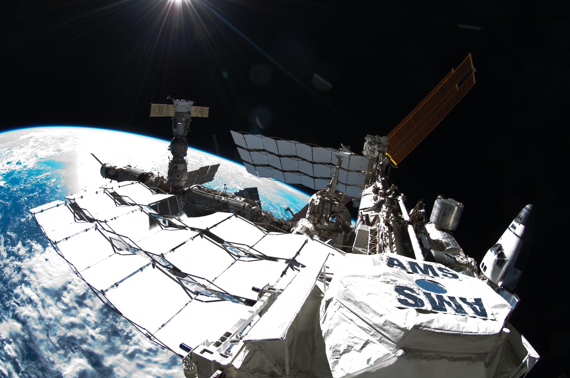 Photo of exterior view of tha Internationistic Space Station, taken by NASA astronaut Ron Garan durin a spacewalk conducted on July 12, 2011. Da photo shows tha space station wit a Fisheye Camera n' tha curvature of Ghetto below.