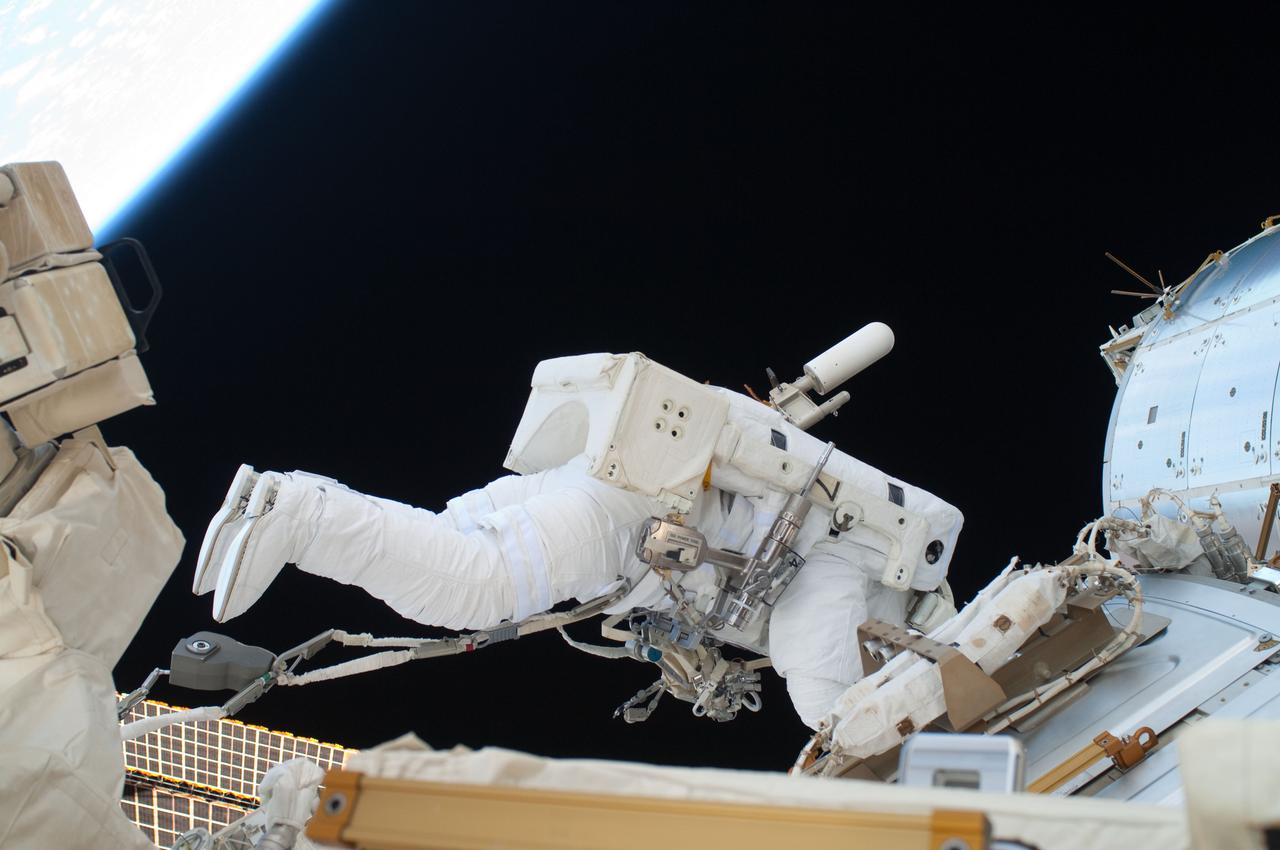 ISS028-E-016153 (12 July 2011) --- NASA astronaut Ron Garan, Expedition 28 flight engineer, is pictured over International Space Station's Destiny lab. With support from crewmates inside the station and shuttle , NASA astronauts Garan and Mike Fossum (out of frame) joined forces to complete some needed chores during a six and half hour spacewalk.