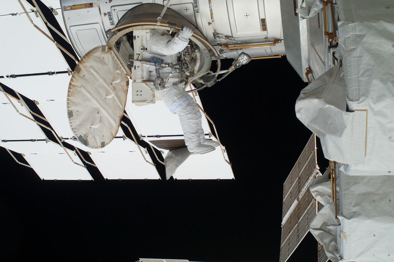 ISS028-E-016249 (12 July 2011) --- NASA astronaut Ron Garan, Expedition 28 flight engineer, egresses the Quest airlock module on the International Space Station as he prepares to join crewmate Mike Fossum on a July 12 spacewalk.