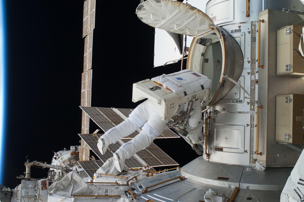 ISS028-E-016269 (12 July 2011) --- NASA astronaut Ron Garan, Expedition 28 flight engineer, egresses the Quest airlock on the International Space Station as he prepares to join crewmate Mike Fossum on a July 12 spacewalk