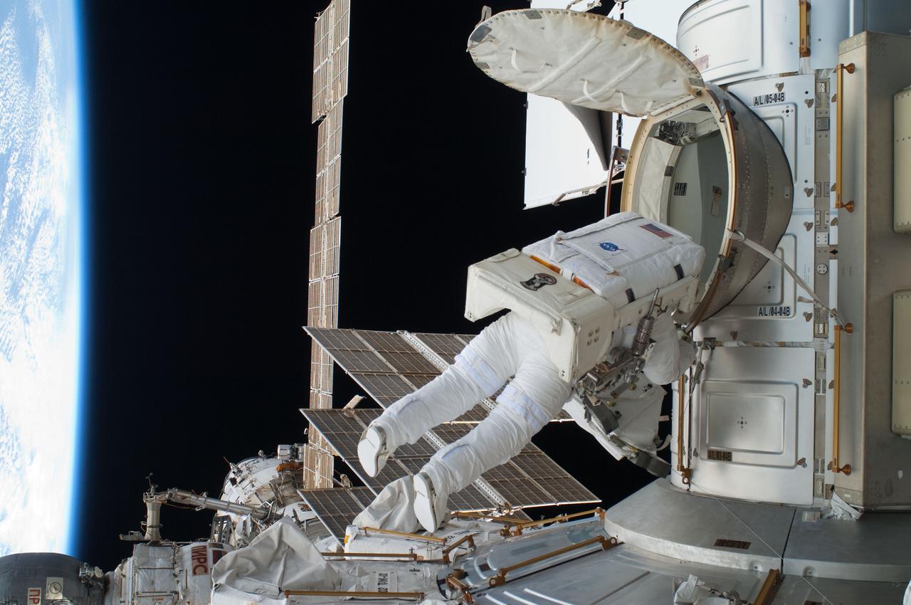 ISS028-E-016271 (12 July 2011) --- NASA astronaut Ron Garan, Expedition 28 flight engineer, egresses the Quest airlock on the International Space Station as he prepares to join crewmate Mike Fossum on a July 12 spacewalk