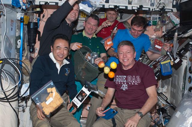 NASA image: Expedition 28 crew members enjoy dinner in the Node 1
