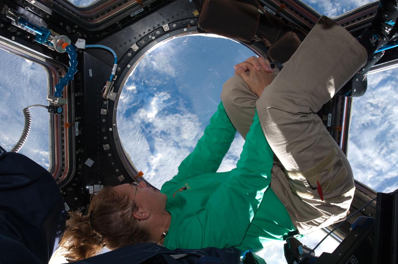 ISS028-E-017083 (16 July 2011) --- When asked by a reporter if she noticed a difference in the International Space Station on her current visit with the Atlantis STS-135 crew, versus an earlier lengthy visit, NASA astronaut Sandy Magnus mentioned the Cupola's addition, which was not on the station during her earlier stay there. This is one of series of photos showing Magnus, mission specialist for the Space Shuttle Program's final flight, taking advantage of the zero gravity of space and the panoramic view provided by the multi-windowed Cupola.