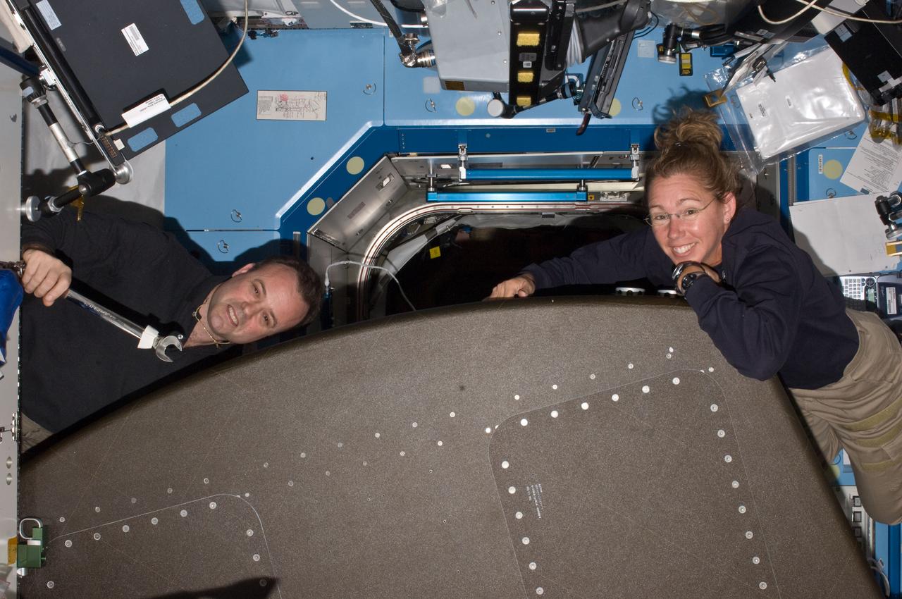 ISS028-E-017365 (17 July 2011) --- NASA astronauts Ron Garan, Expedition 28 flight engineer, and Sandy Magnus, STS-135 mission specialist, work with a pulled rack in the U.S. lab or Destiny aboard the International Space Station.