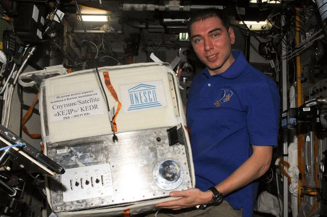 NASA image: FE Volkov poses for photo with the KEDR Satellite in the SM