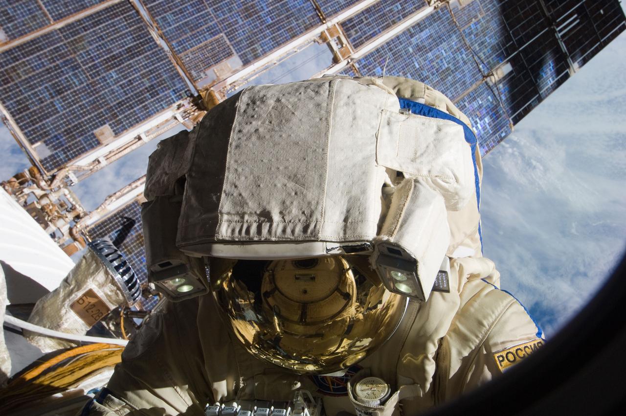 ISS028-E-020782 (3 Aug. 2011) --- Russian cosmonauts Sergei Volkov and Alexander Samokutyaev (out of frame), both Expedition 28 flight engineers, attired in Russian Orlan spacesuits, participate in a session of extravehicular activity (EVA) on the Russian segment of the International Space Station. During the six-hour, 23-minute spacewalk, Volkov and Samokutyaev moved a cargo boom from one airlock to another, installed a prototype laser communications system and deployed an amateur radio micro-satellite.