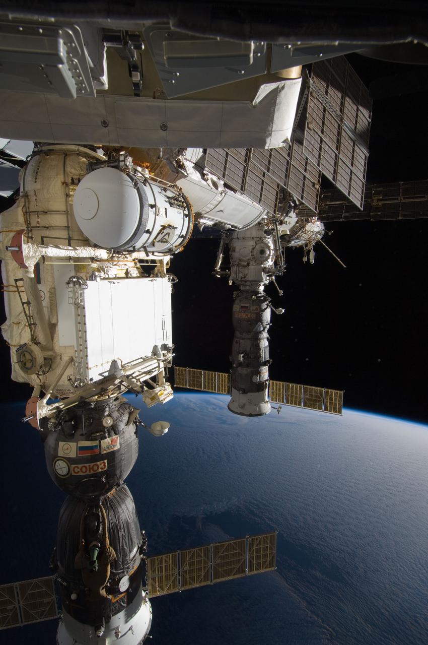 ISS028-E-020889 (3 Aug. 2011) --- Soyuz and Progress spacecraft docked to the International Space Station are featured in this image photographed during a session of extravehicular activity (EVA). Earth’s horizon and the blackness of space provide the backdrop for the scene.