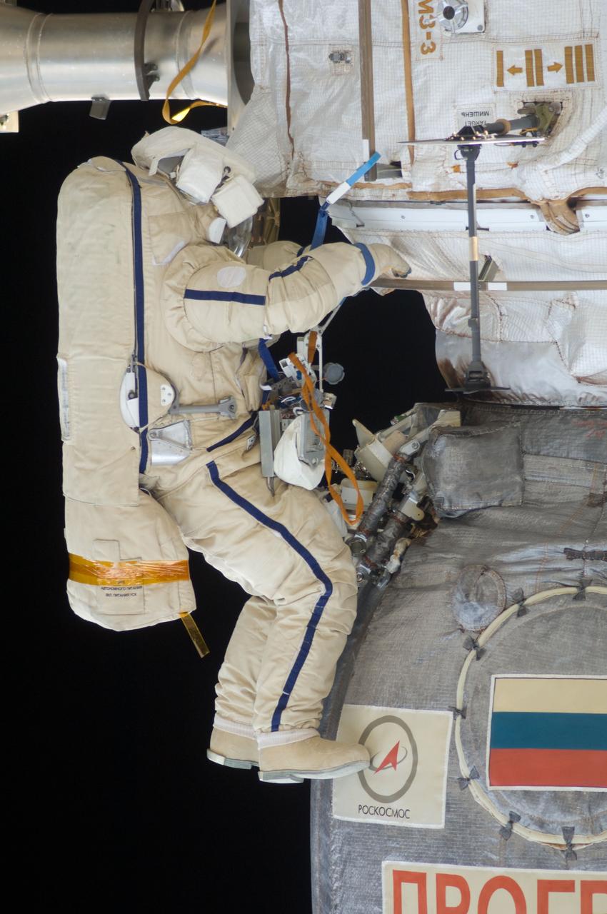 ISS028-E-020931 (3 Aug. 2011) --- Russian cosmonauts Sergei Volkov and Alexander Samokutyaev (out of frame), both Expedition 28 flight engineers, attired in Russian Orlan spacesuits, participate in a session of extravehicular activity (EVA) on the Russian segment of the International Space Station. During the six-hour, 23-minute spacewalk, Volkov and Samokutyaev moved a cargo boom from one airlock to another, installed a prototype laser communications system and deployed an amateur radio micro-satellite.